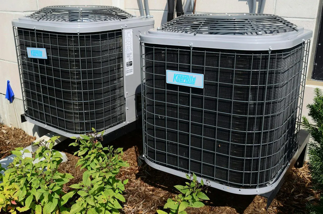 Two air conditioners are elevated off the ground to prevent ice build-up around the condenser, ensuring proper airflow and function in Yulee Florida