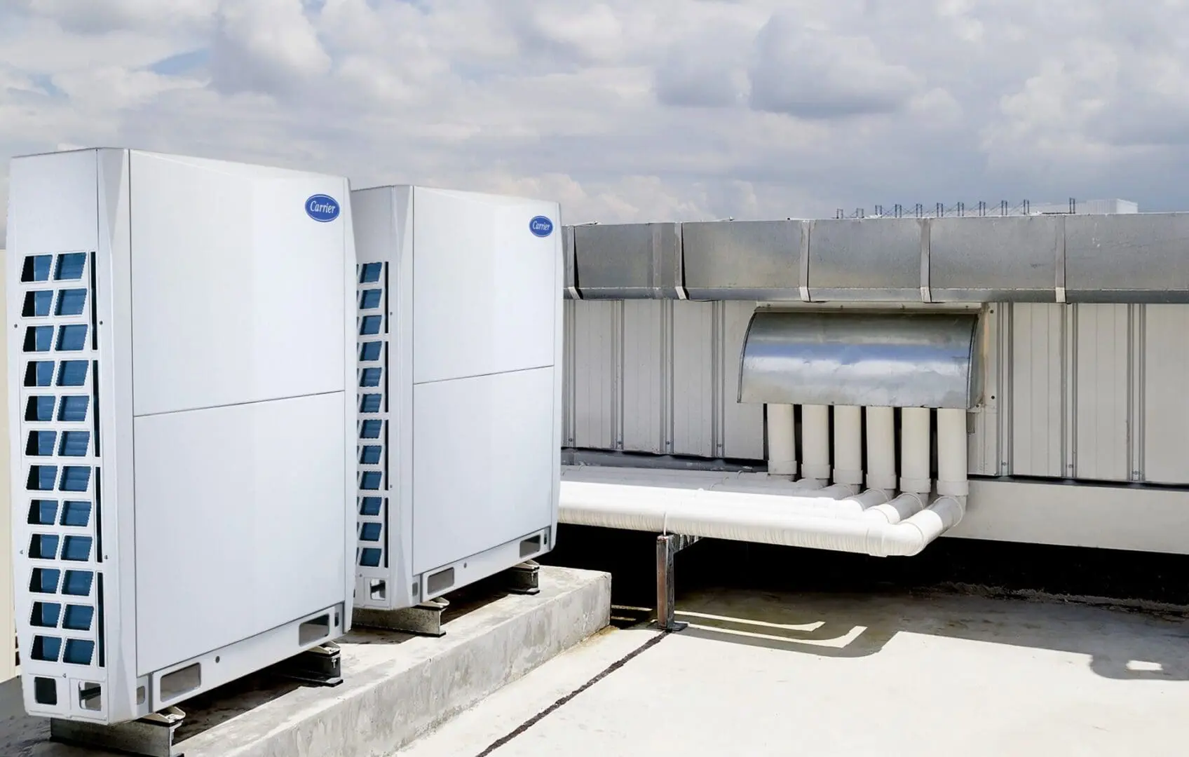 Air Conditioning Units Installed on a Rooftop A couple of air conditioning units are installed on the roof of a building, securely positioned for efficient cooling and proper ventilation