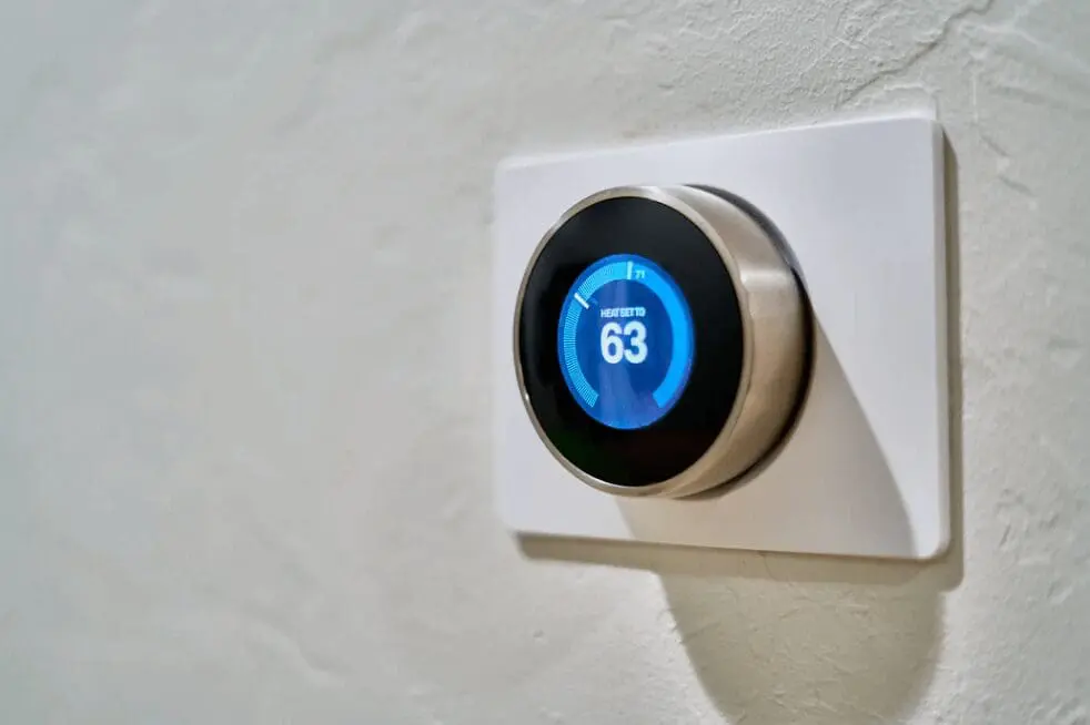 air conditioning repair Jacksonville A smart thermostat is mounted on the wall.