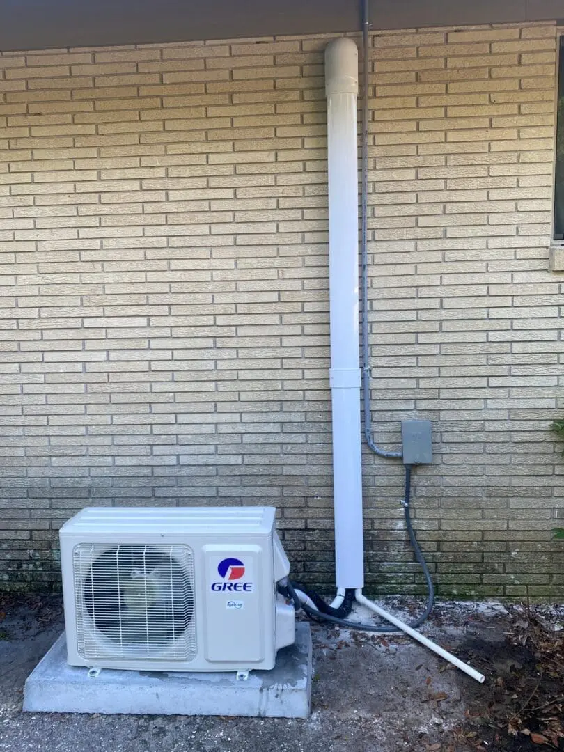 A small ductless air conditioning unit is installed outside a building in Orange Park, Florida, mounted securely for efficient cooling and ventilation