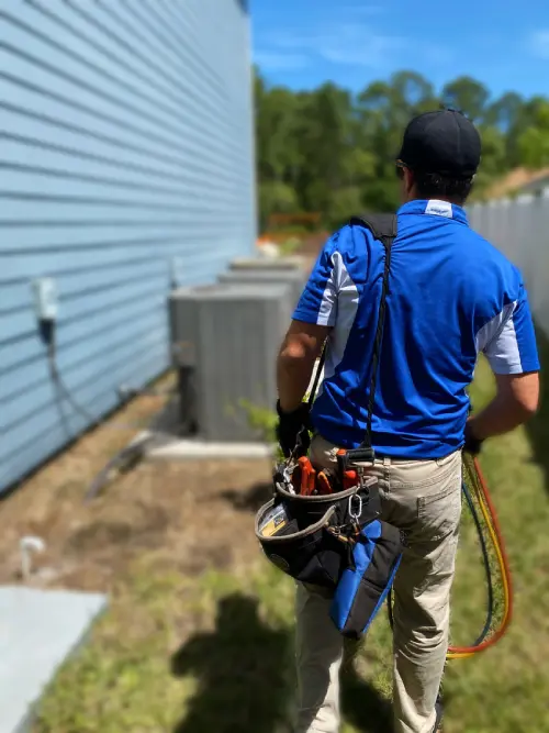 HVAC Technician Carrying Tools to Repair a Heating Unit An HVAC technician, dressed in a uniform, is carrying tools to repair a heating unit, prepared to troubleshoot or replace components for efficient operation in Callahan, FL