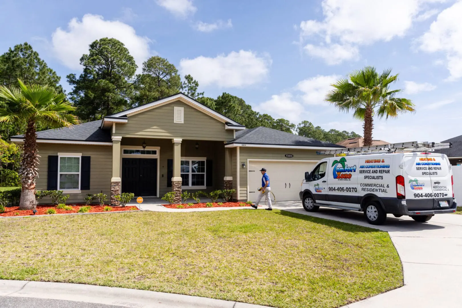 An air conditioning service van is parked in the driveway of a modern home in Wildlight, Florida, surrounded by lush greenery and a clean suburban setting.