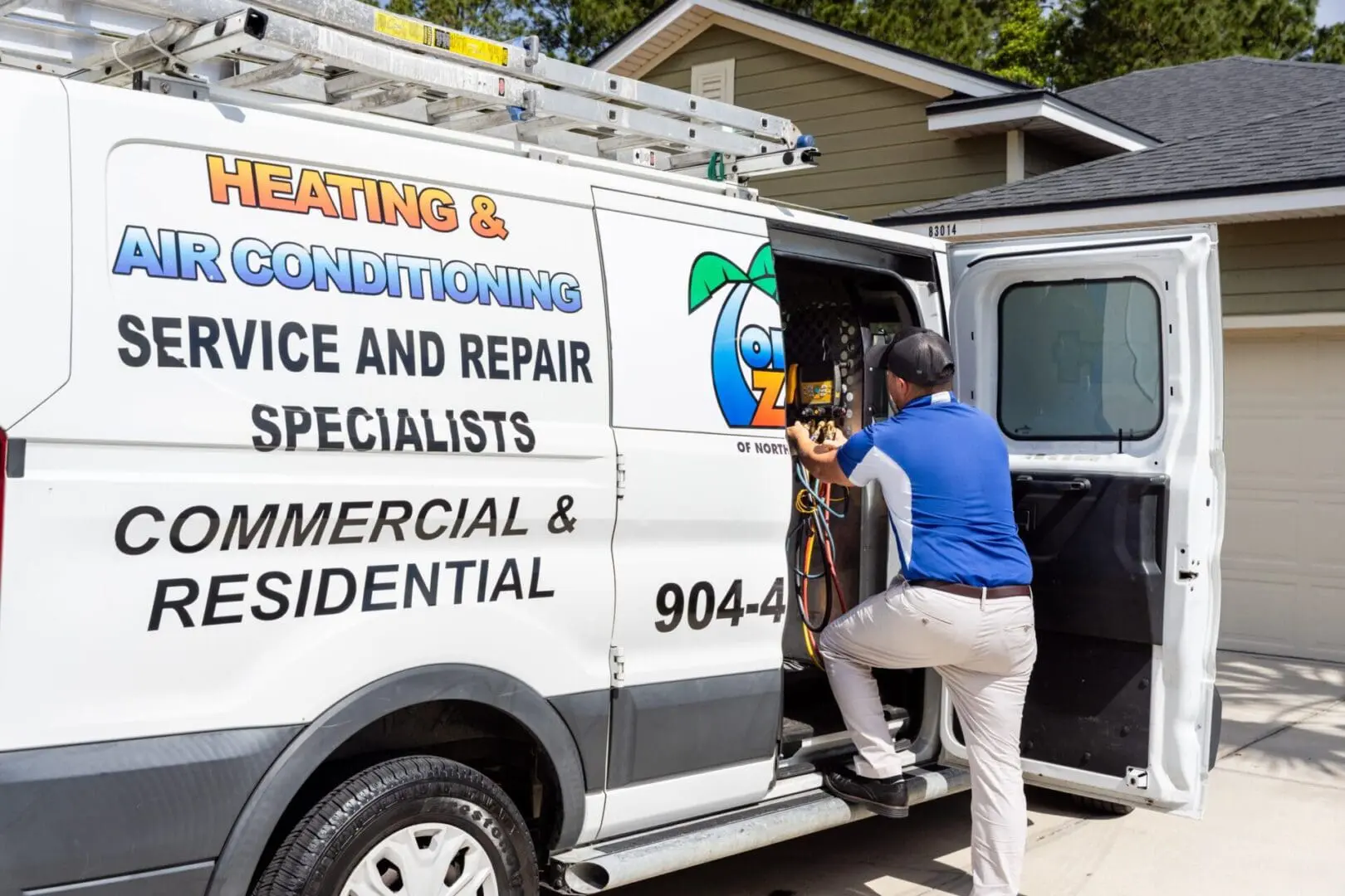 Comfort Zone AC Tech Comfort Zone of North Florida Air Conditioning Tech getting parts out of company van for a repair