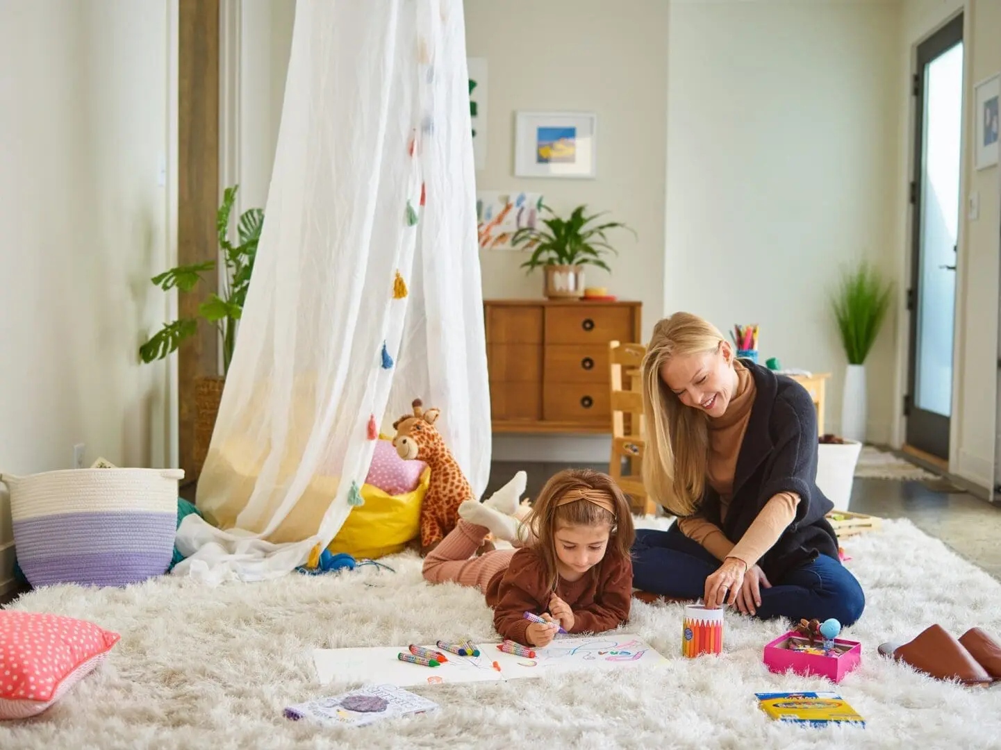 Mom and daughter playing on a rug in the air conditioning room in Jacksonville Florida
