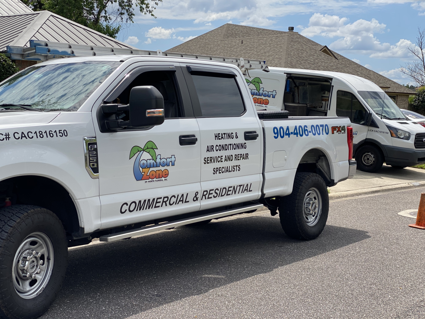 Comfort Zone of North Florida Company vehicles parked in front of a residential home during an air conditioning installation