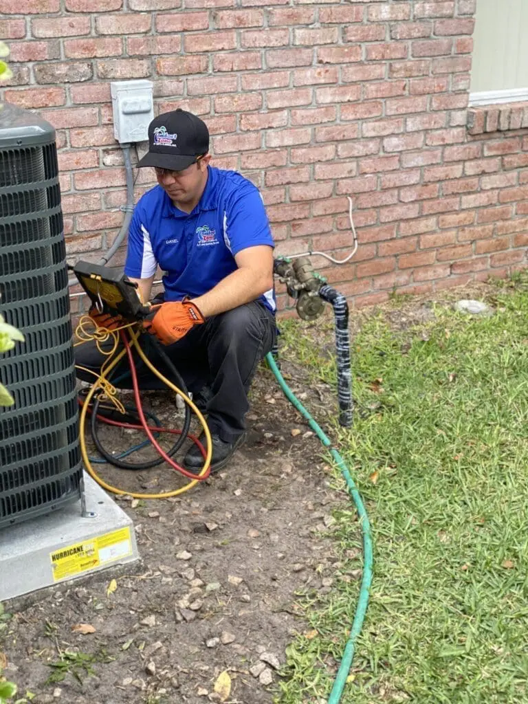 AC tech checking Freon levels in an air conditioning unit to ensure optimal cooling performance in a Jacksonville home.