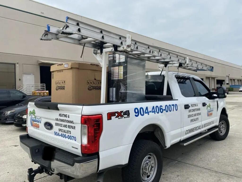 Air conditioning company loading truck with equipment and materials for a new AC system installation in Jacksonville.