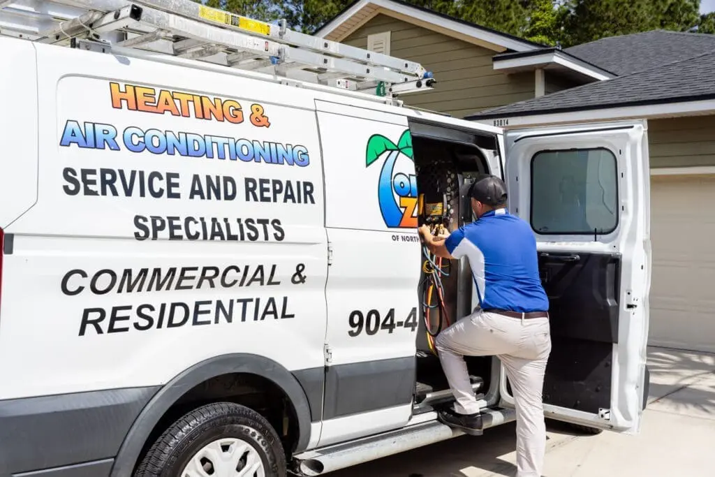 AC tech retrieving parts and tools for air conditioning repair service in Yulee, ensuring expert service and quick repairs.