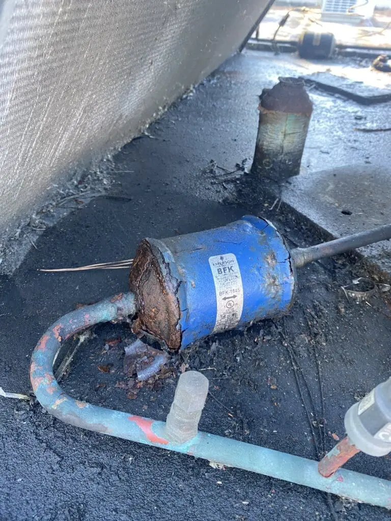 Refrigerant leak in an air conditioning unit caused by rust and corrosion, reducing cooling efficiency in a Jacksonville home.