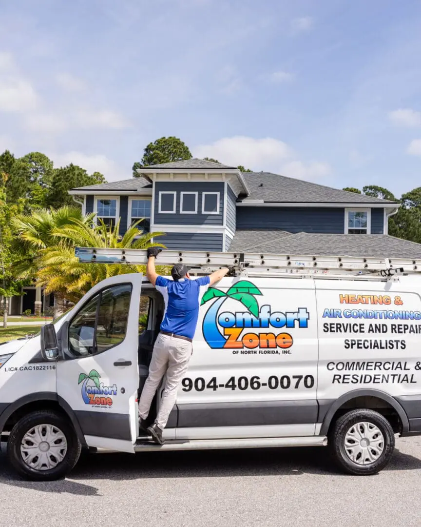 air conditioning company van in Yulee, FL Air Conditioning Service technician removing a ladder from the work van