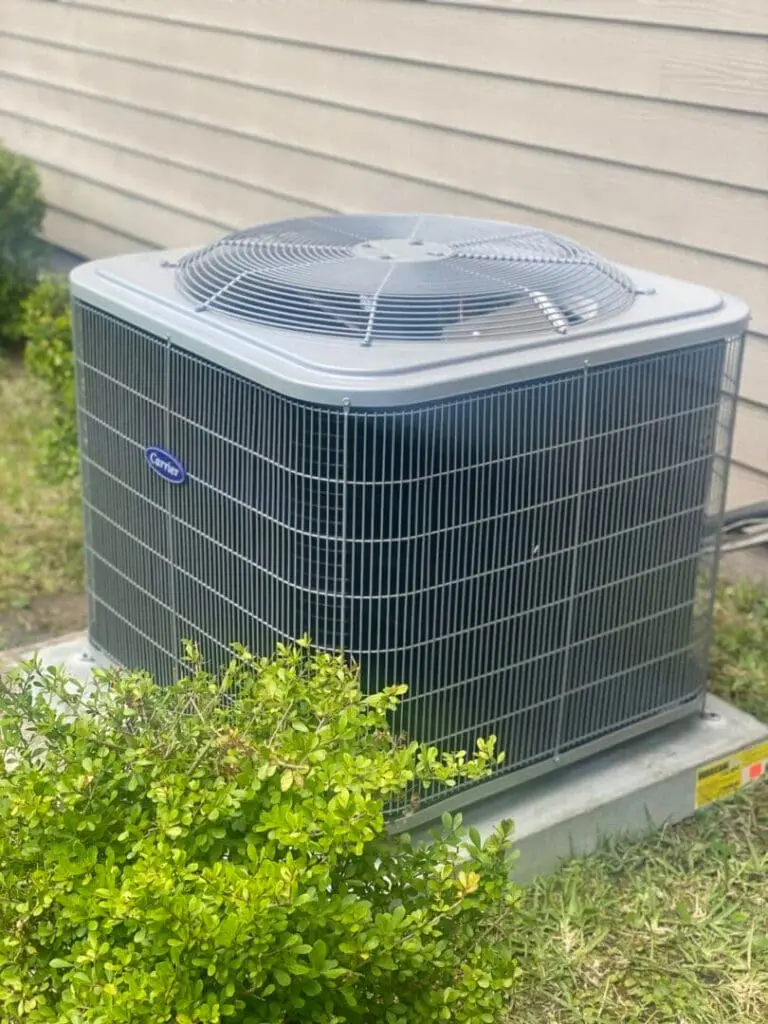 Carrier heat pump on a concrete pad outside of a home in Jacksonville Florida