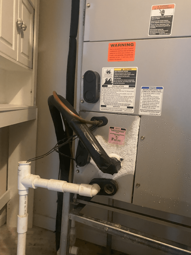 Frozen AC unit requiring repair to restore proper cooling performance in a Jacksonville home