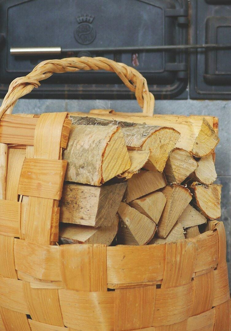 A basket of wood is shown with the handle on it.