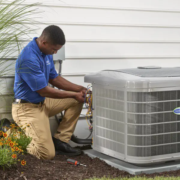 A man working on an air conditioner outside.