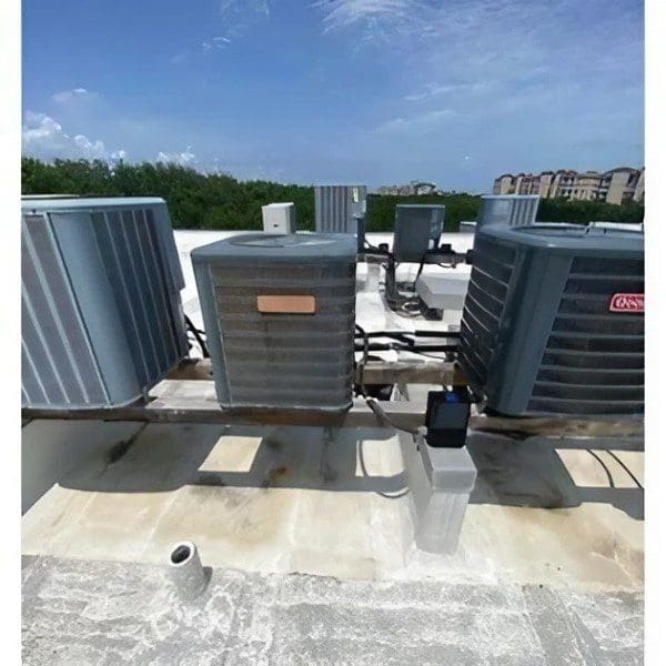 A group of air conditioners on the roof.