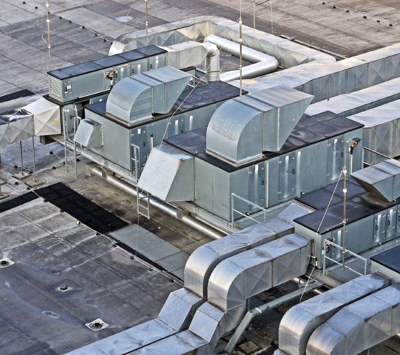 A view of an industrial building with many ventilation systems.