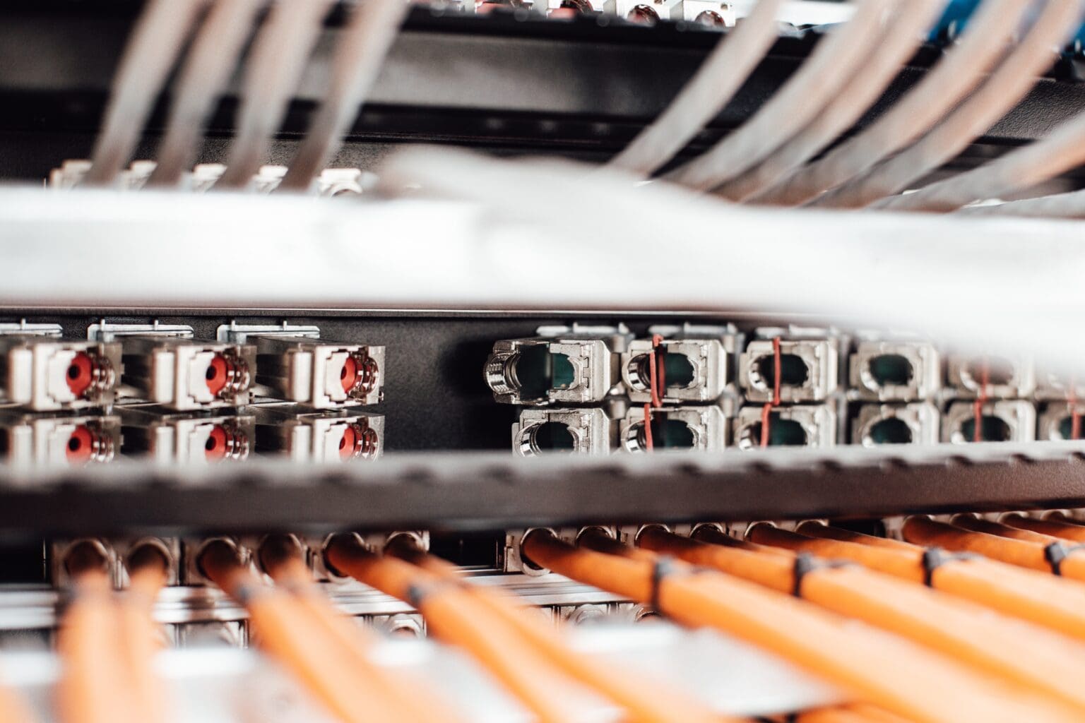 Close-up view of network cables and switches in a server rack, highlighting the intricacies of network connections and data communication hardware.