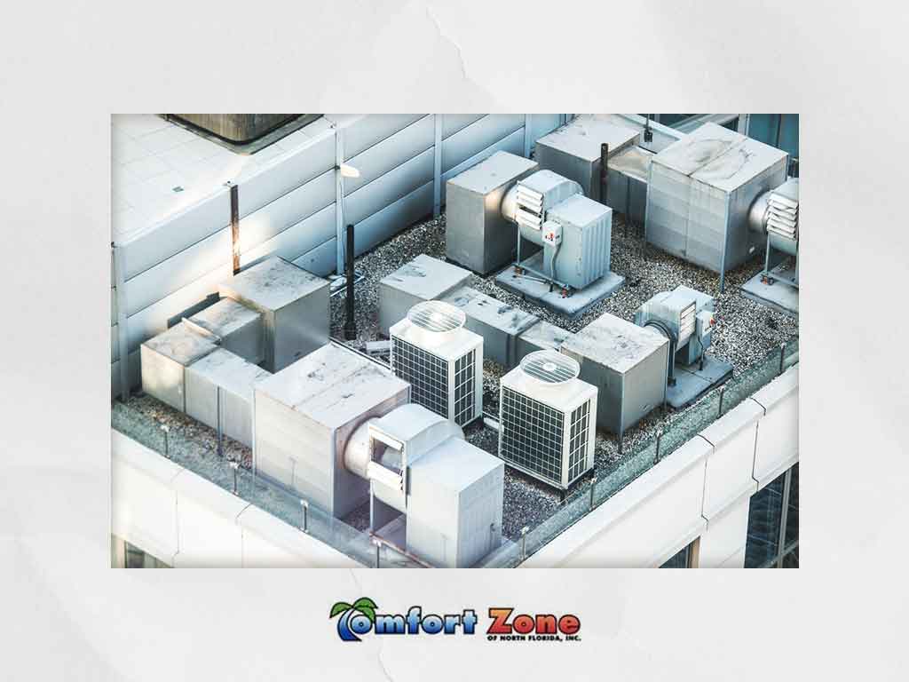 Aerial view of industrial hvac units on a building roof with the logo "comfort zone" displayed at the bottom.