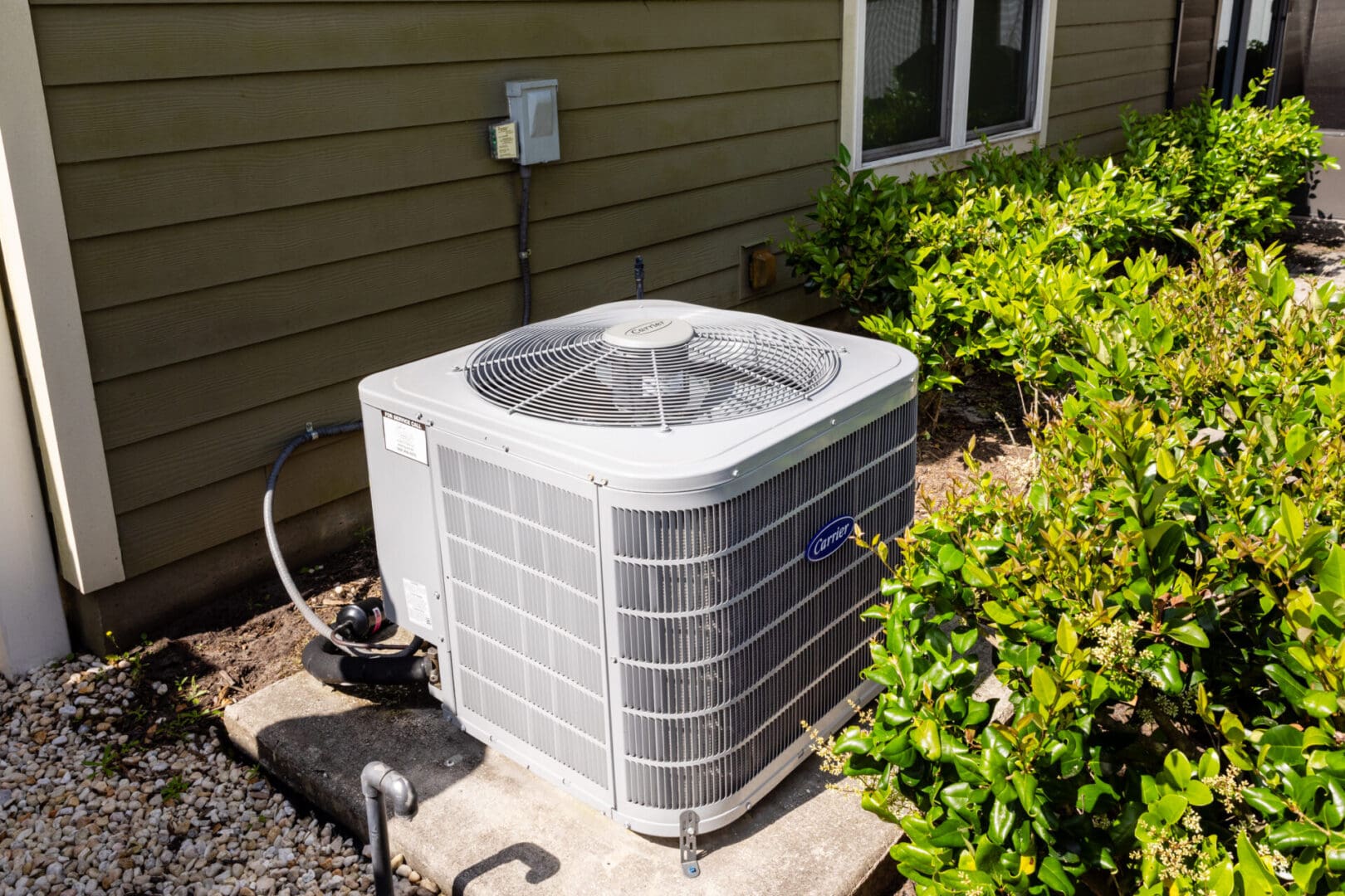 A residential air conditioner sitting outside of a residential house in Jacksonville