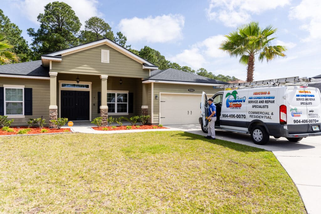 An air conditioning service technician exiting a company service van at a home in Jacksonville, Florida