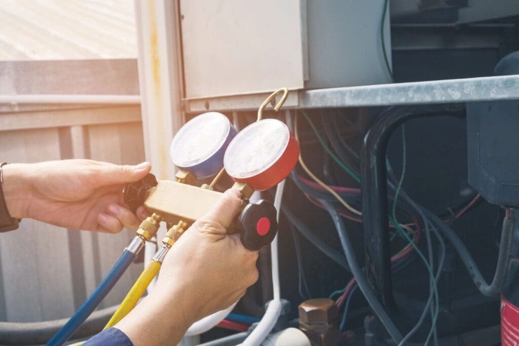 An air conditioning technician checking refrigerant levels with gauges in Jacksonville's northside