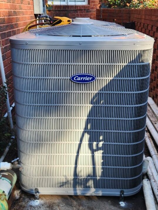 A Carrier air conditioning unit on a concrete slab outside of a residential home in Jacksonville, Florida