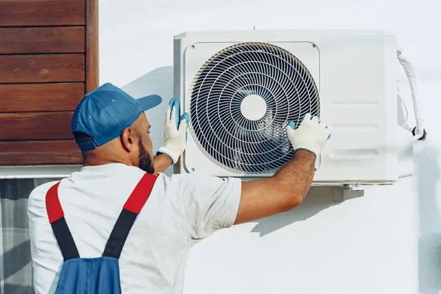 repairman-uniform-installing-outside-unit-air-conditioner-27baeb4e-640w
