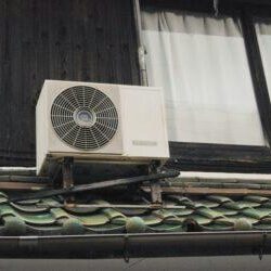A small air conditioner on the side of a building.