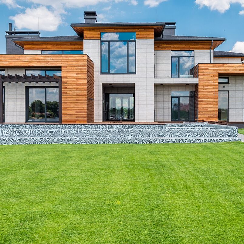 A large house with a well-maintained lawn, symbolizing Comfort Zone Heating and Cooling's commitment to cleanliness and professionalism