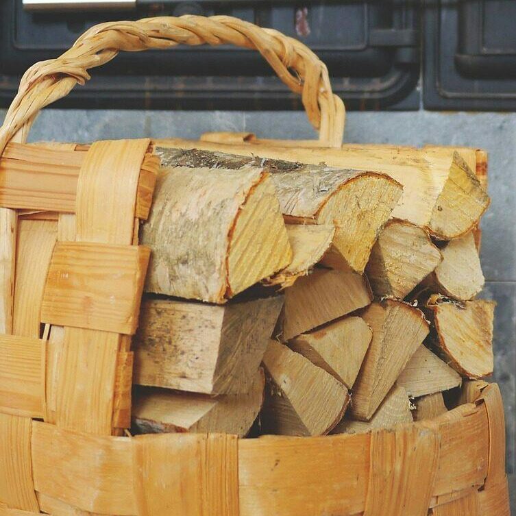 A basket of wood is shown with the handle on it.