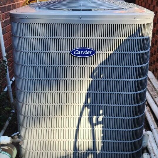 A Carrier air conditioning unit on a concrete slab outside of a residential home in Jacksonville, Florida