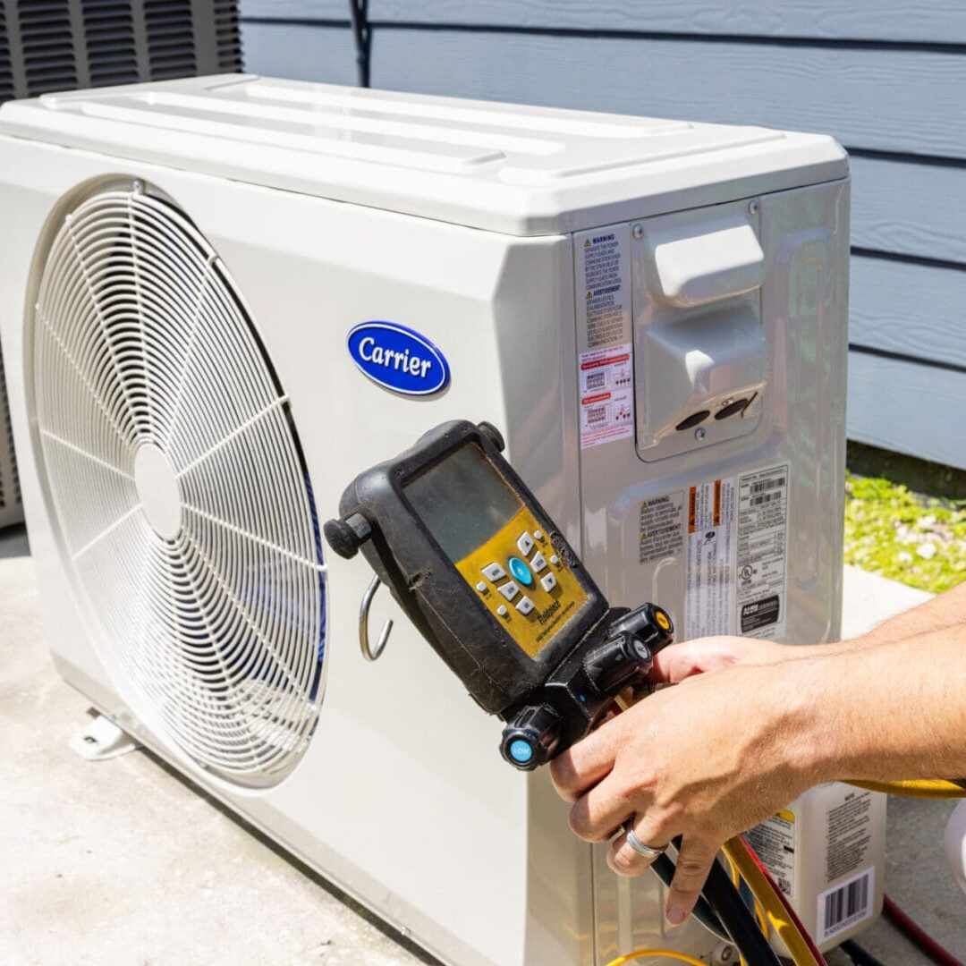 An AC Repair Service man is using an air conditioner tool to cool it.