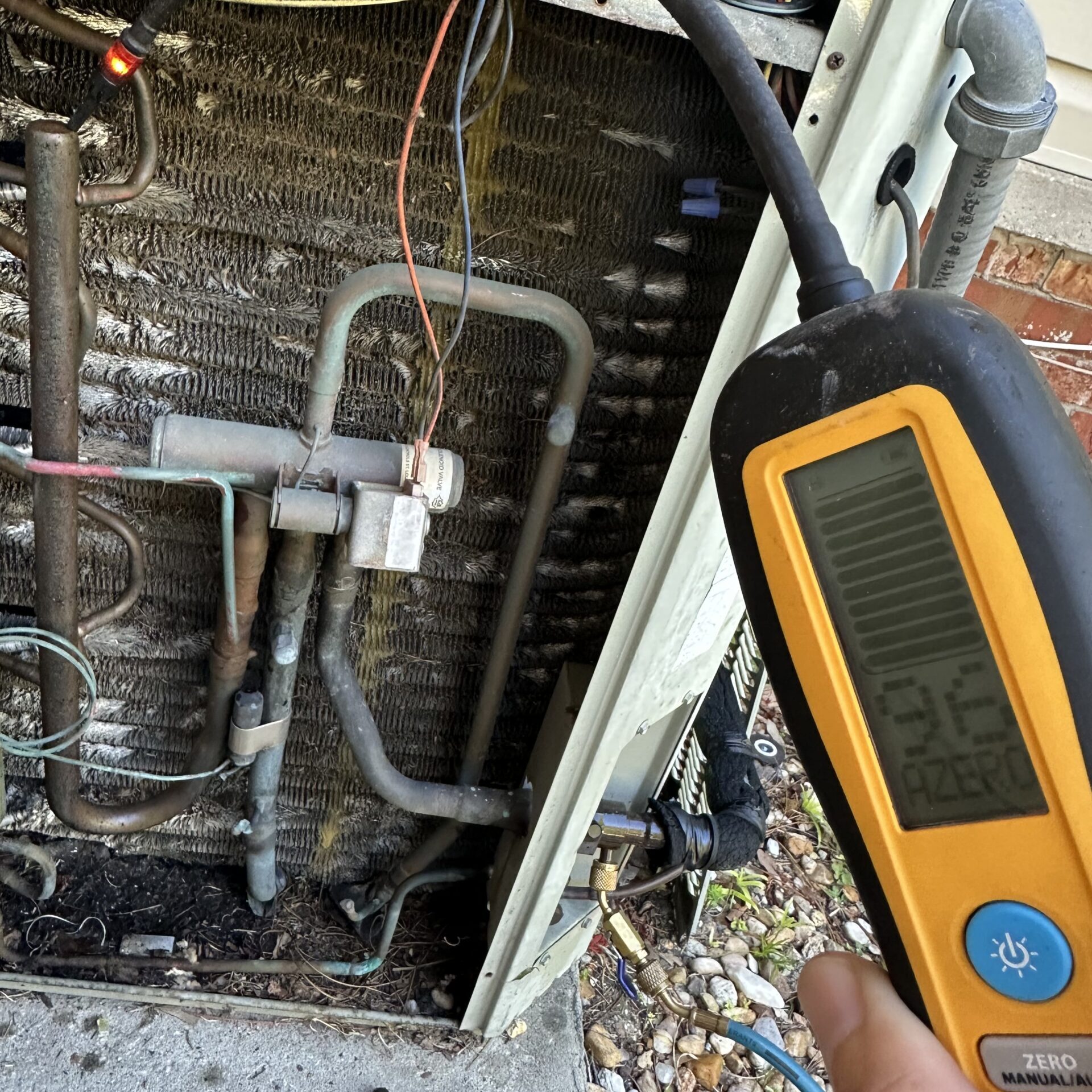 A licensed technician performing a diagnostic check to identify why an air conditioning unit stopped working during a Jacksonville heatwave.