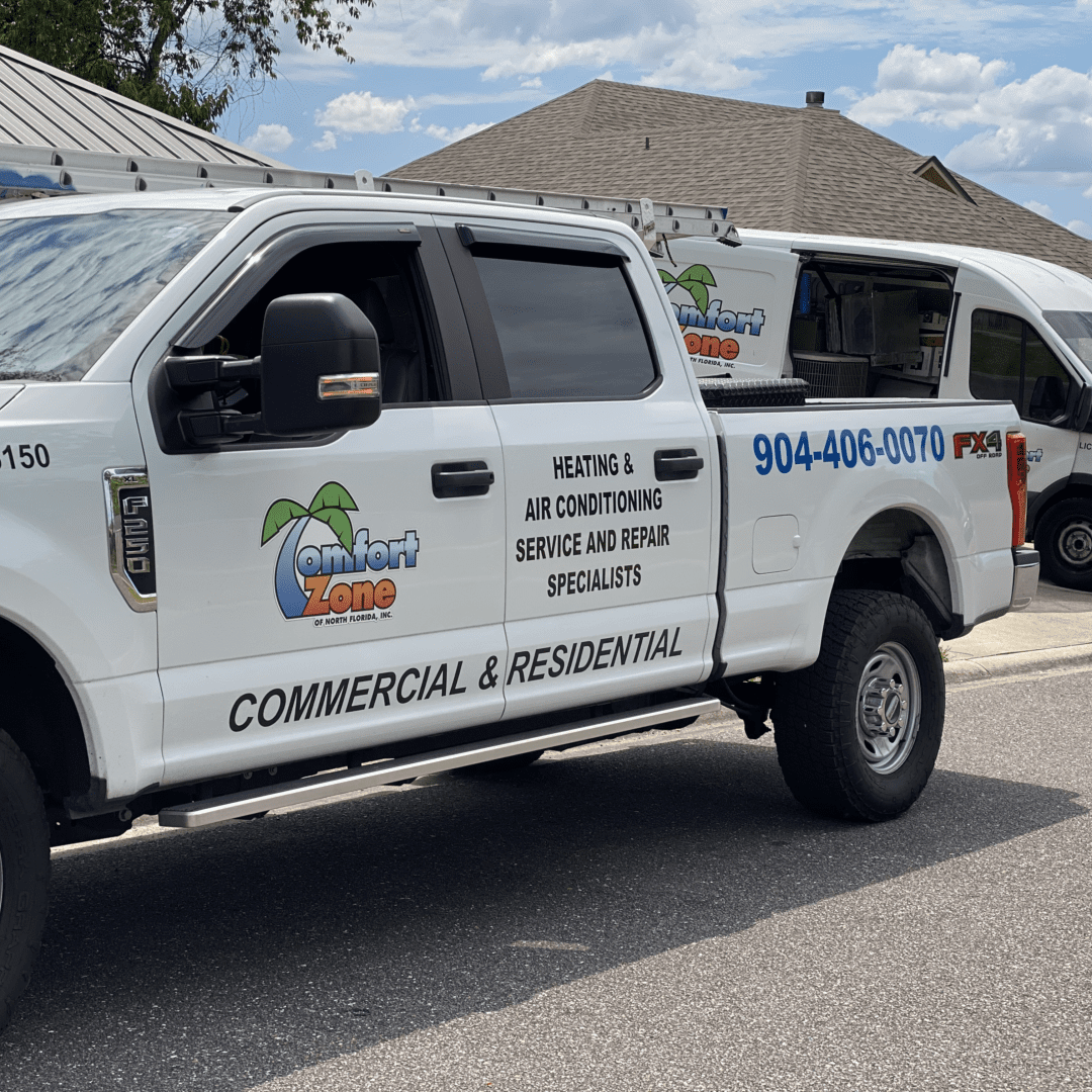 Comfort Zone of North Florida Company vehicles parked in front of a residential home during an air conditioning installation