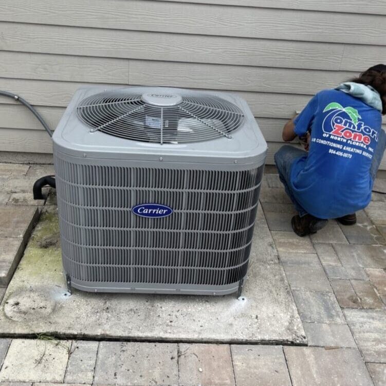 An air conditioning technician installing a new unit in Jacksonville.