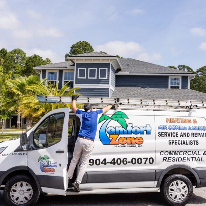 Air Conditioning Service technician removing a ladder from the work van