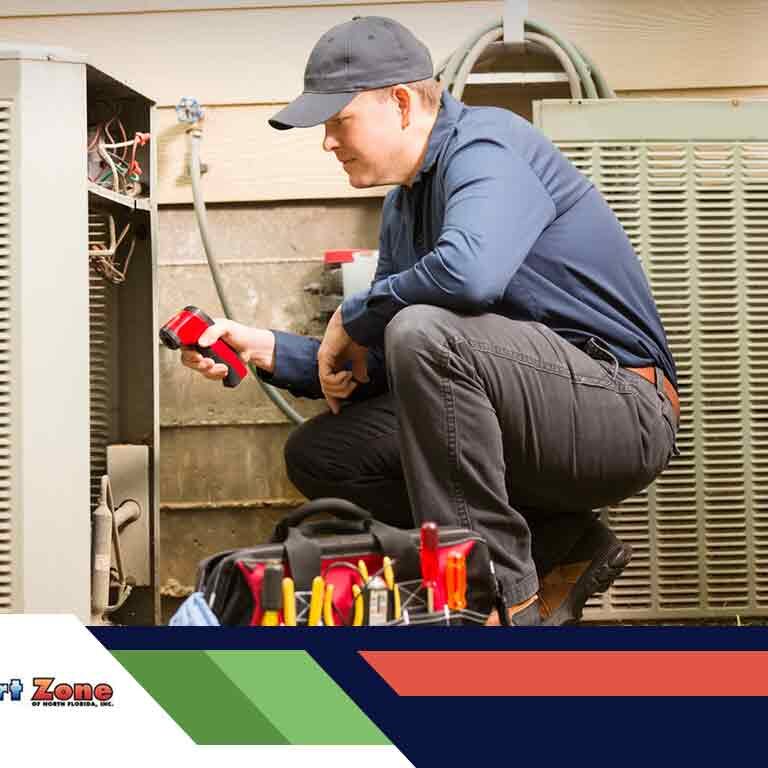 A technician repairs an hvac unit, equipped with tools, focused on fixing the equipment indoors.